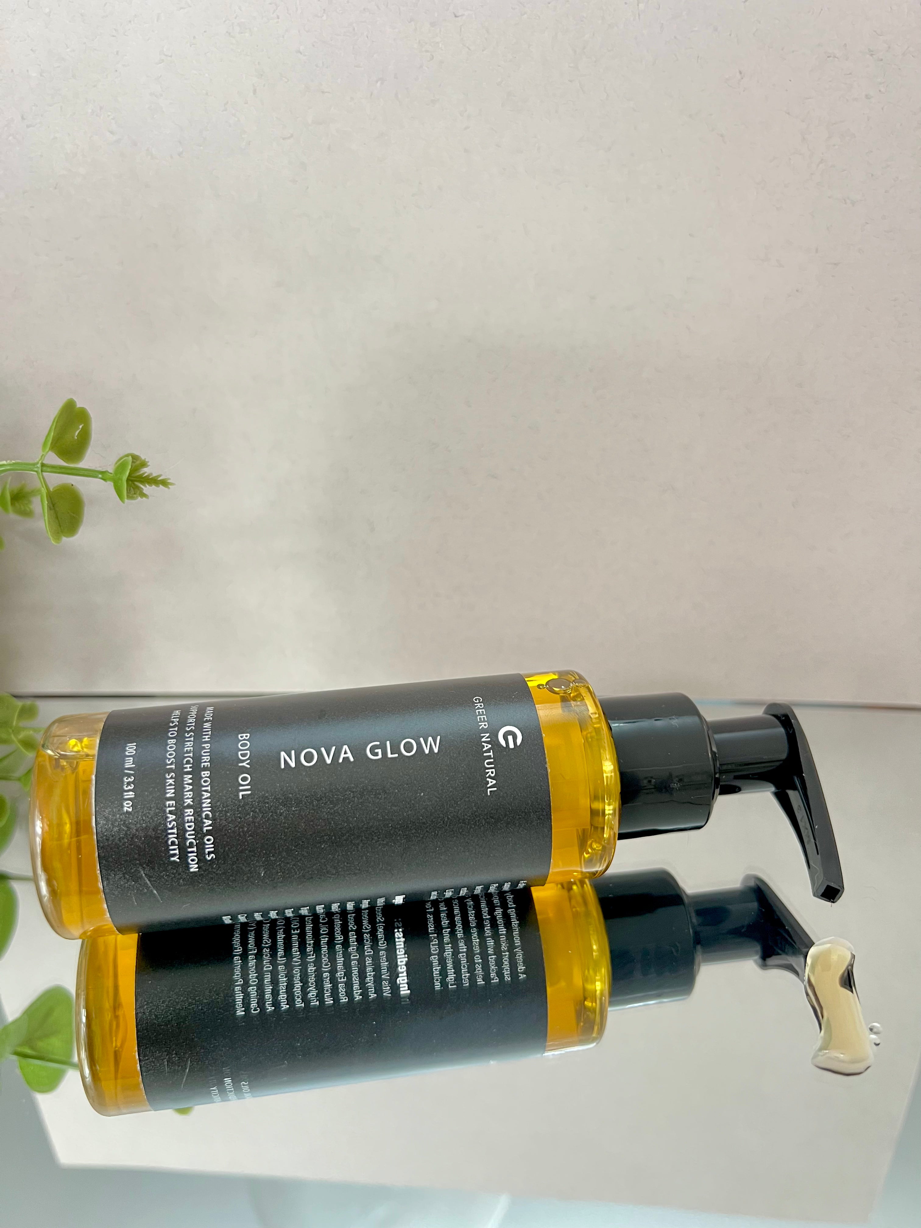 Bottle of Nova Glow oil with pump caps on a light gray background.
