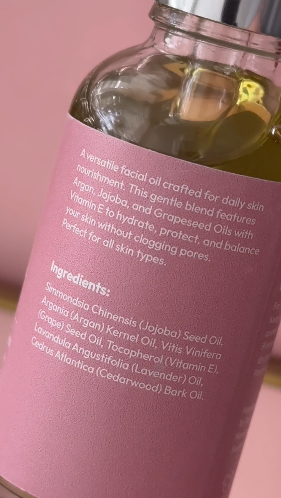 Lumira Facial oil bottle with pink label and text detailing product features and ingredients.