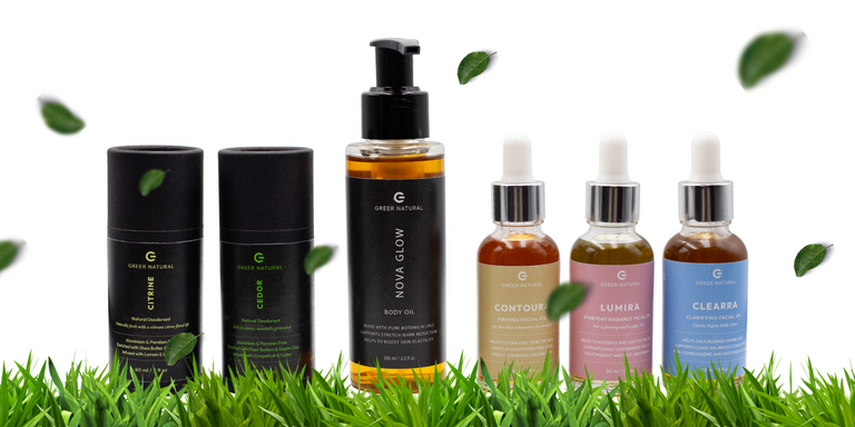 Line of skincare products with green leaves on a white background